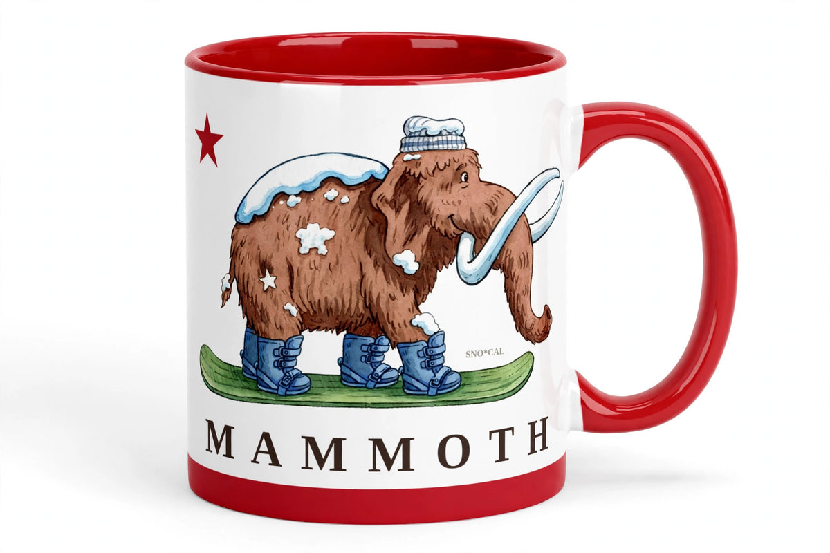 White ceramic mug with red rim handle and inside with Mammoth CA flag design, woolly mammoth snowboarding, angled view
